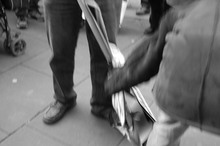 With a struggle, one of our placards was grabbed off us.